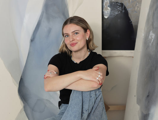 Joy Kinna is sittting on the floor