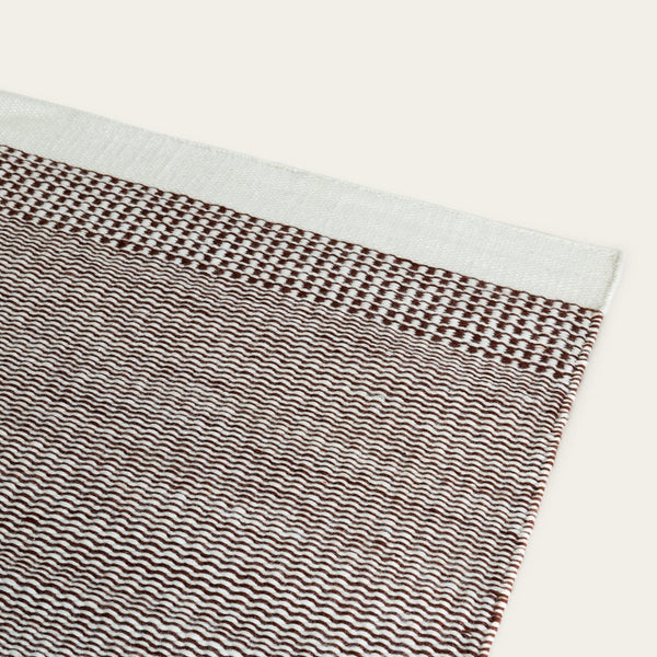 Textile with wavy pattern on a white background #burntsienna
