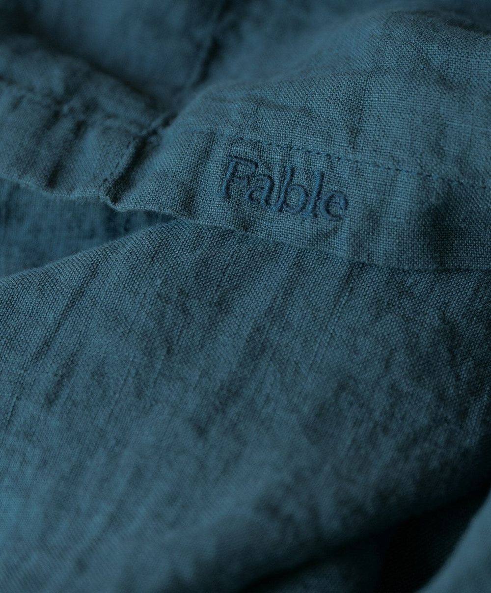 Linen Flat Sheet by Fable Home, shown in Storm Blue.