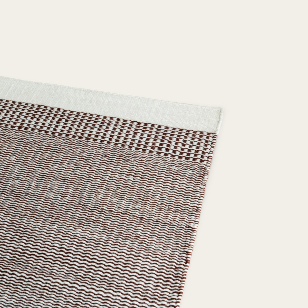 Linear Wool Rug by Fable Home, shown in Burnt Sienna.