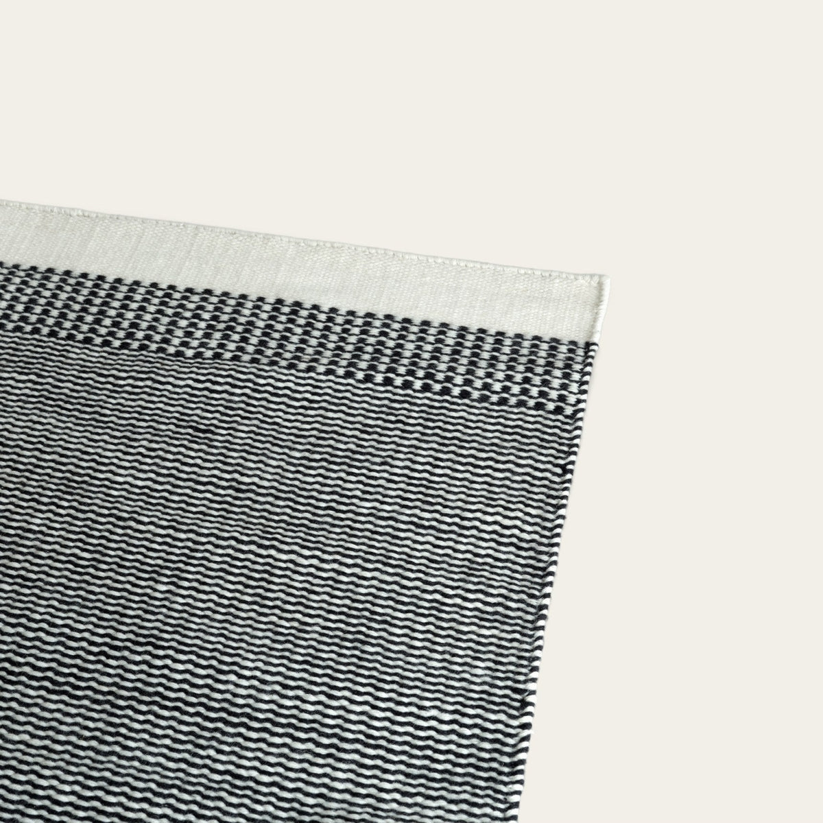 Linear Wool Rug by Fable Home, shown in Ash Black.