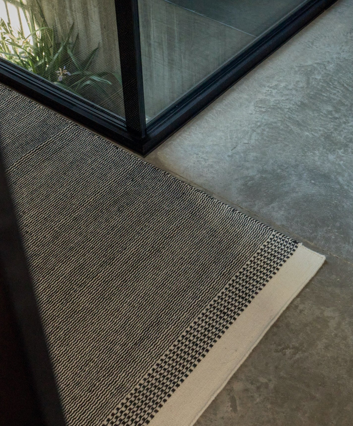 Linear Wool Rug by Fable Home, shown in Ash Black.