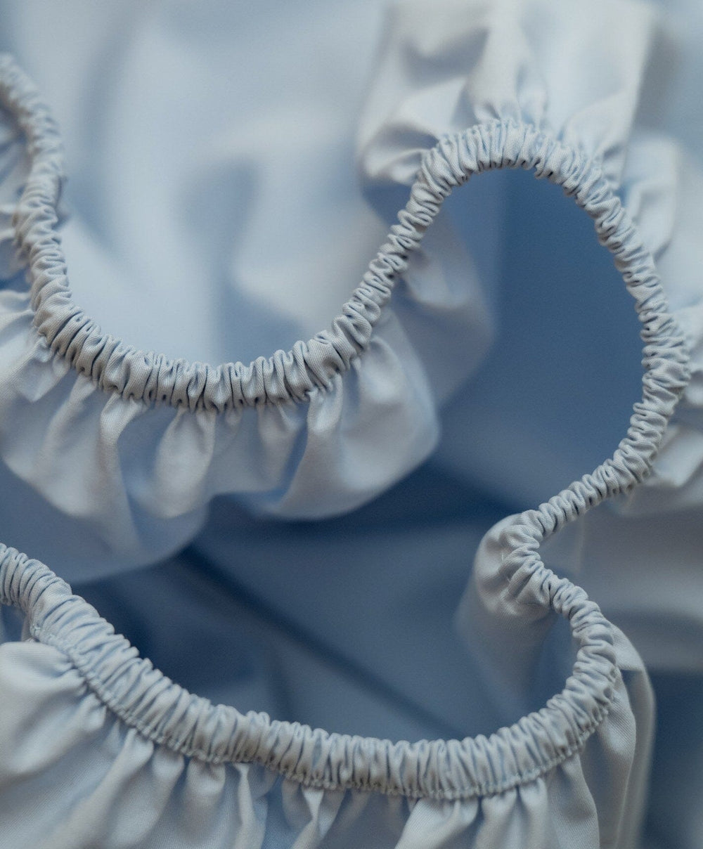 Percale Fitted Sheet by Fable Home, shown in Meadow Blue.