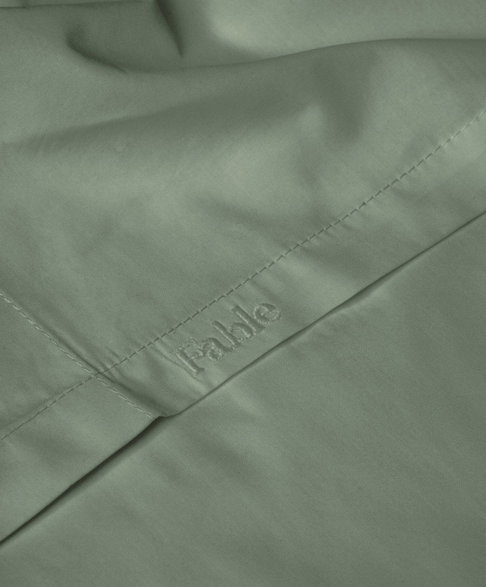 Percale Flat Sheet by Fable Home, shown in Juniper Green.