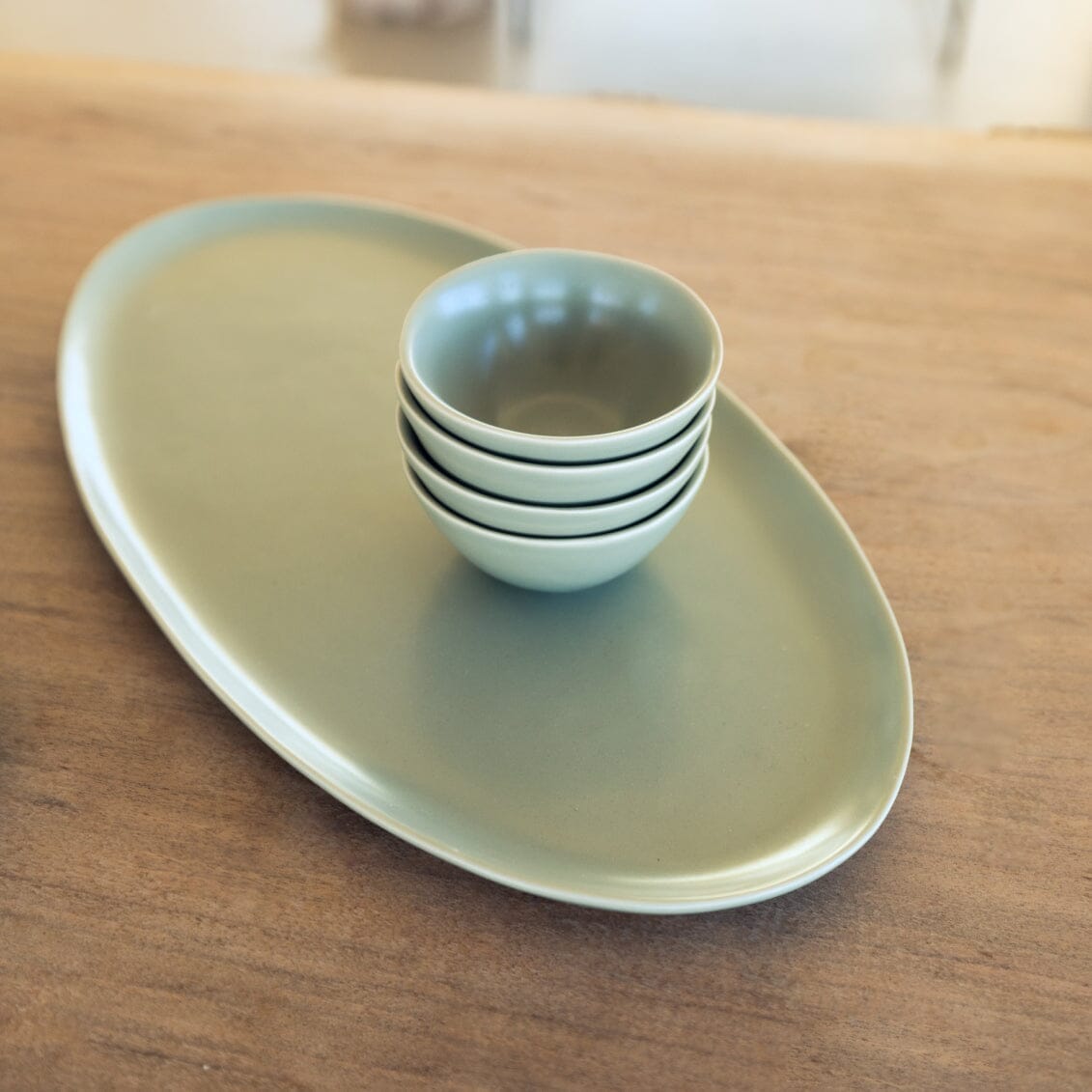 Serving ceramics set bundles by Fable Home, shown in a beachgrassgreen finish.