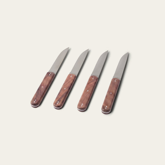 Four steak knives with wooden handles on a light gray background #walnut