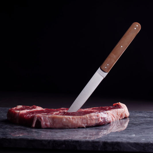 Raw steak with a knife on a dark surface #natural